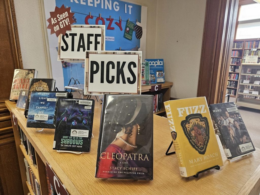 Books are displayed on a shelf top on the second floor of the library.